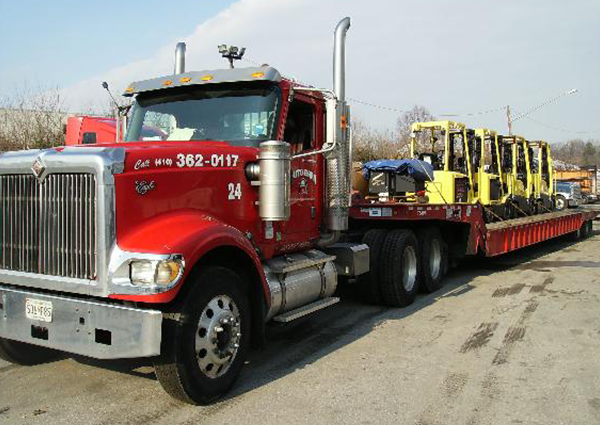 Truck Towing Heavy Machinery