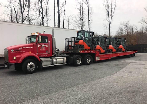 Truck With Four Orange Forklifts