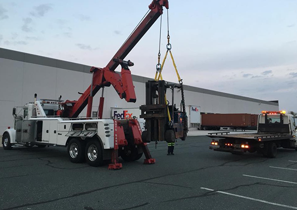 Workers Transporting Forklift